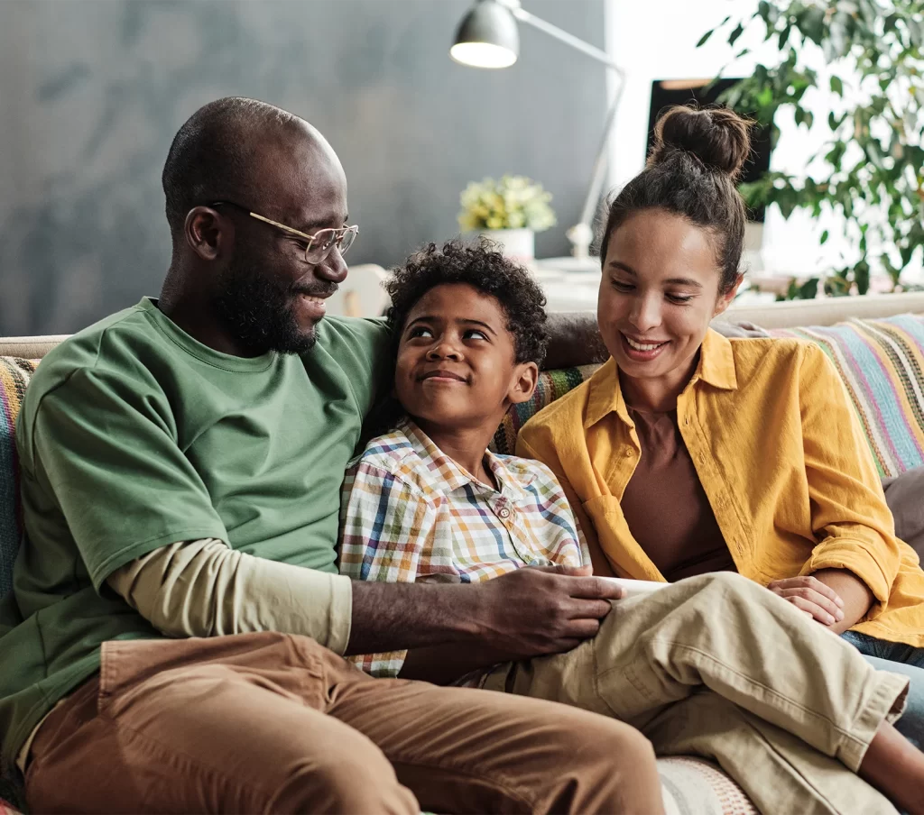 happy adopted son looking up at his dad with love
