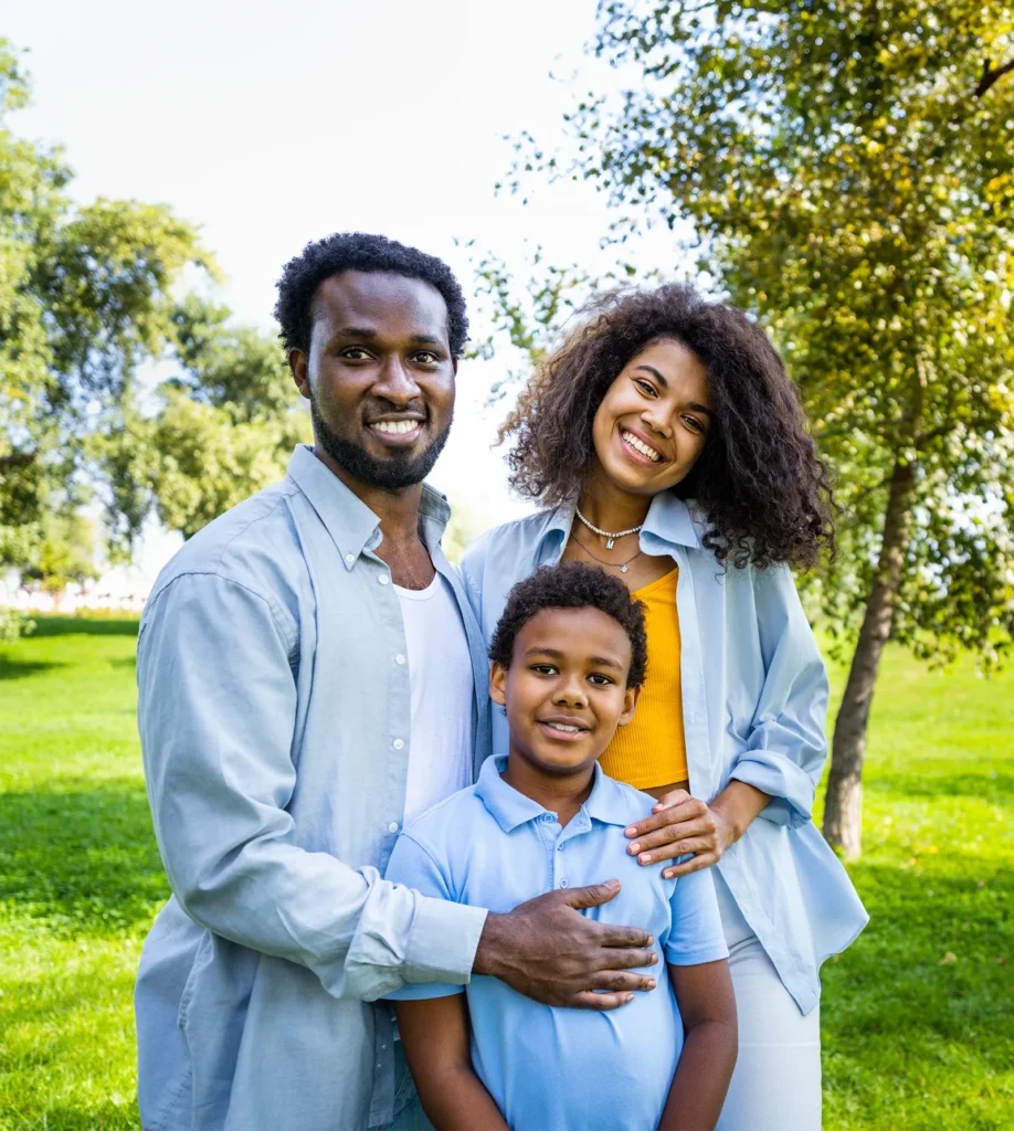 smiling foster parents with their foster son